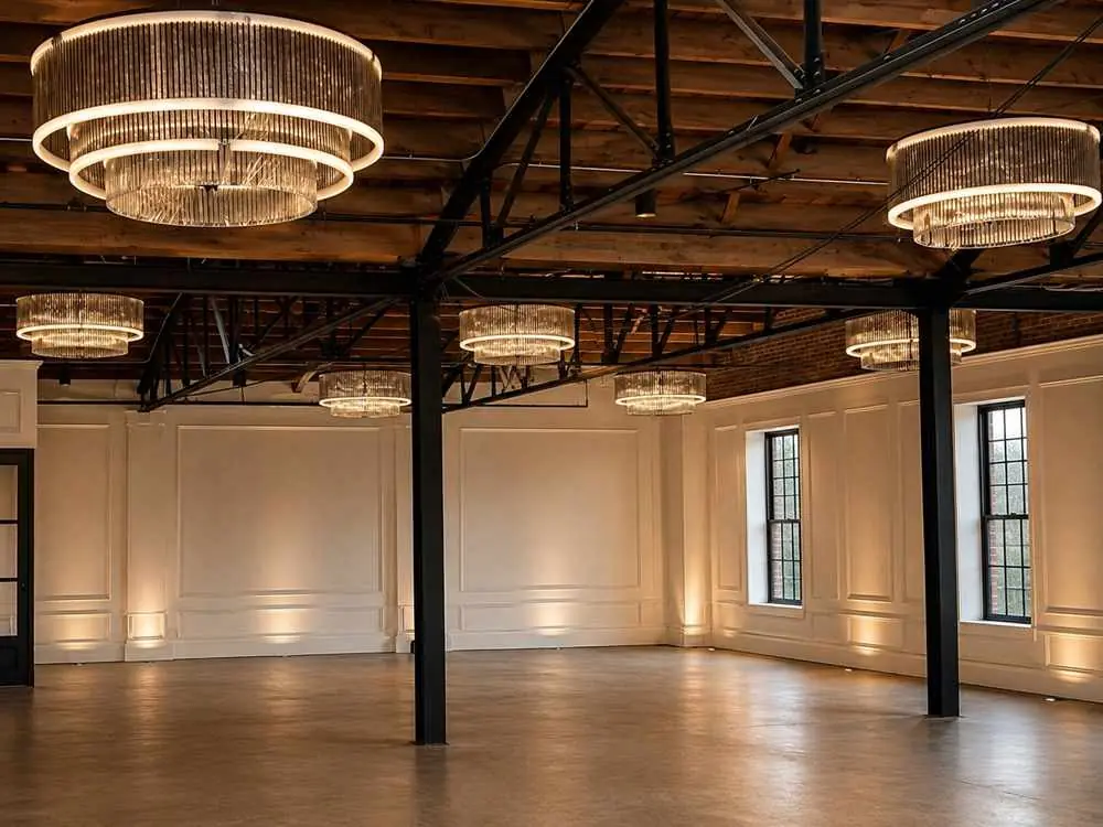 Empty indoor event space with chandeliers and exposed beams showing a Houston gala venue layout at Grand Central Houston in EaDo